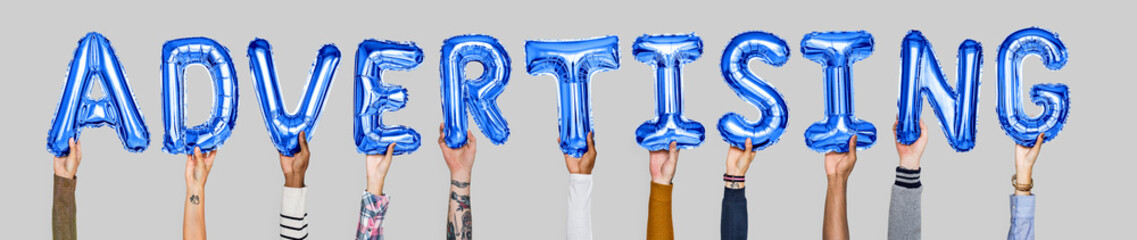 Hands holding advertising word in balloon letters
