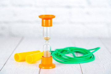 Fintess concept. Skipping-rope and hourglass