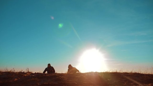 Two Tourists Jumping Happy Happiness goal achievement Nature Landscape. teamwork. two tourists hikers men and dog with backpacks walking at sunset go hiking trip. slow motion video. journey and hikers