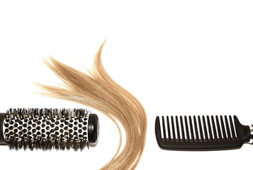 Obraz premium Woman hair styling with hair brushes