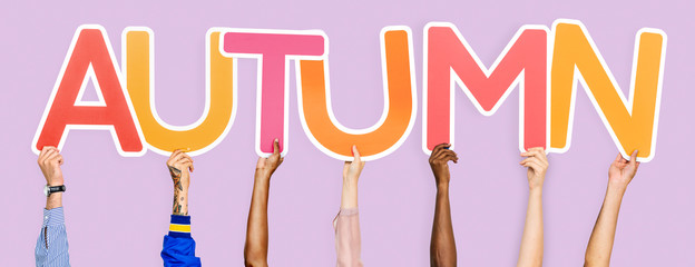 Hands holding the word Autumn