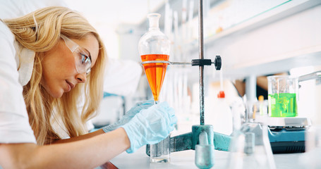 Attractive student of chemistry working in laboratory