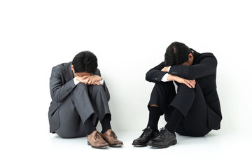 sad business group sitting on white background