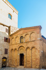 Fototapeta na wymiar View at facade of church of San Bartolo in the streets of San Gimignano in Italy