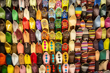 Fototapeta na wymiar Colorful handmade leather slippers (babouches) on a market in Marrakech, Morocco