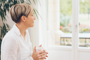 Woman enjoying a mug of coffee or tea