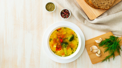 Healthy bright spring vegetable dietary vegetarian soup with broccoli, top view, long banner format, copy space