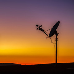 Horizon with silhouette of a satellite at sunset