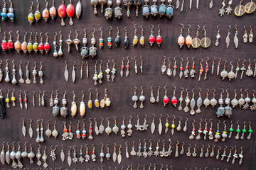 Wall full of colorful natural wooden jewelry and ethnic jewelry in the Medina of Marrakech, Morocco.