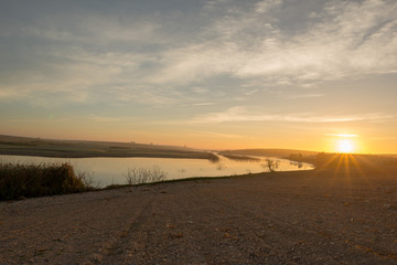 The sun at dawn by the Guadiana river