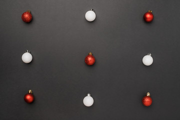 Red and white balls on black background.