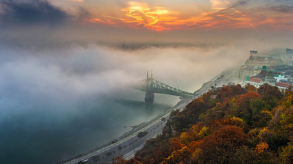 Budapest, Hungary - Panoramic view of mysterious foggy sunrise with Liberty Bridge (Szabadsag hid) and hazy skyline of Budapest at autumn morning