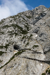 View of a zigzaging mountain road leading to the eisriesenwelt ice cave Eisriesenwelt in Austria.