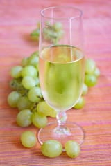 grape-harvest time. White wine and bunch of grapes