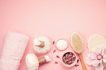 Feminine beauty and spa products, tools and cosmetics over the pink background