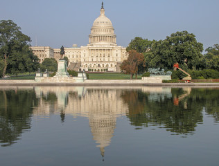 Fototapeta premium West side of the United States Capitol Building in Washington, DC. Landmark with trees and lake on a sunny day