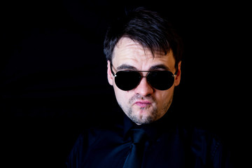 Fototapeta premium white man black background in black aviators