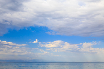 Blue sky with white cumulus clouds. Abstract natural background. Perfect summer day in the countryside.