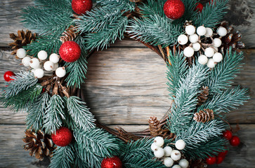 Fototapeta na wymiar Merry Christmas and happy New year. Christmas decorative wreath on wooden background. Background with copy space. Horizontal. Selective focus.