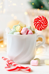 Merry Christmas and happy New year. Cup of cocoa and marshmallows on a light background. Selective focus. Christmas background.