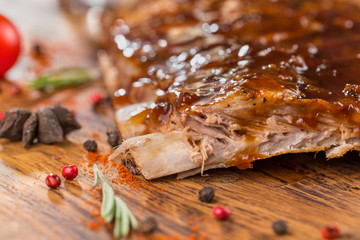 Delicious barbecued ribs seasoned with a spicy basting sauce and served with chopped fresh...
