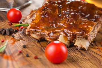 Delicious barbecued ribs seasoned with a spicy basting sauce and served with chopped fresh...