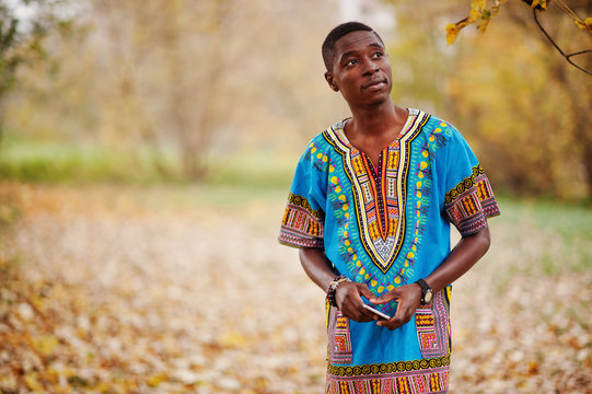 African Man In Africa Traditional Shirt On Autumn Park.