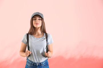 Young woman in stylish t-shirt on color background