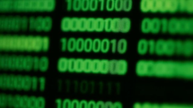 Close up footage of endless lines of computer green code, selective focus.