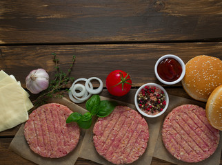 Burger patties on wooden surface