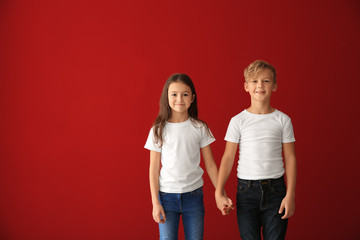Obraz premium Cute children in t-shirts on color background