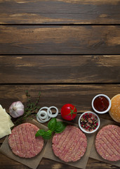 Burger patties on wooden surface