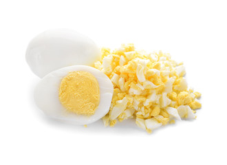 Whole and cut boiled eggs on white background