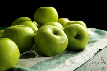 Ripe tasty apples on color table