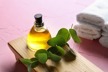 Obraz na płótnie Canvas Bottle of eucalyptus essential oil on wooden stand