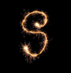 Sparklers forming letter S on dark background