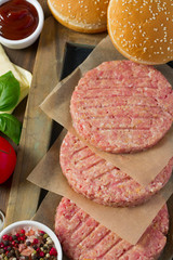 Burger patties on wooden surface
