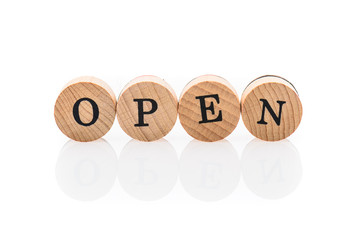 Word Open from circular wooden tiles with letters children toy.