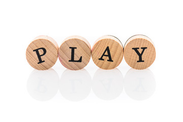 Word Play from circular wooden tiles with letters children toy.