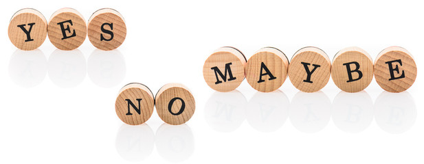 Words Yes No Maybe from circular wooden tiles with letters.