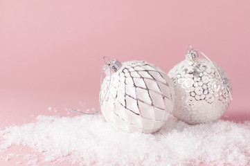 Vintage Christmas New Year balls in the snow on pink background Flat Lay copy space. Holiday Baubles, beautiful Decoration Festive decor, celebration Xmas holiday greeting card