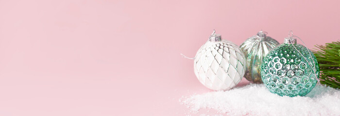 Vintage Christmas New Year balls in the snow and pine branches on pink background Flat Lay copy space. Holiday Baubles, beautiful Decoration Festive decor, celebration Xmas holiday greeting card