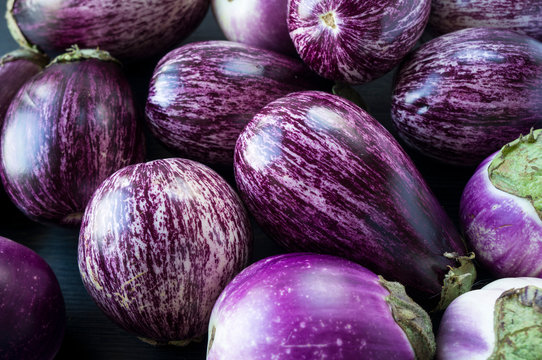 Background of fresh eggplant. Aubergine vegetable. Purple eggplant (aubergine). Top view. Purple food.