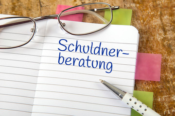 Eintrag im Notizbuch: Schuldnerberatung