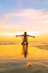 Fototapeta premium Beautiful Woman at the beach in Thailand at sunset