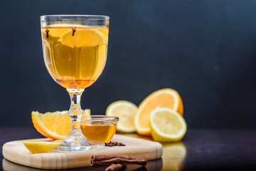 grog, mulled white wine on a dark background with orange. close up. isolated. space