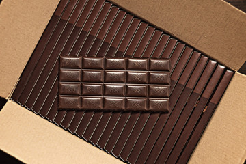 Dark chocolate on a cardboard box. Top view