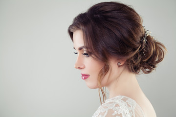 Pretty bride woman with bridal hair. Updo haircut with pearls hairdeco, face closeup © millaf (Nemchinova)
