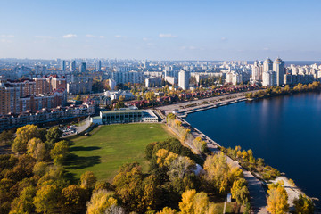 Fototapeta na wymiar Aerial: Natalka park in Obolon district in Kyiv, autumn time