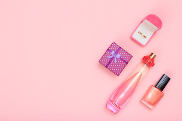 Gift boxes and cosmetics on a pink background